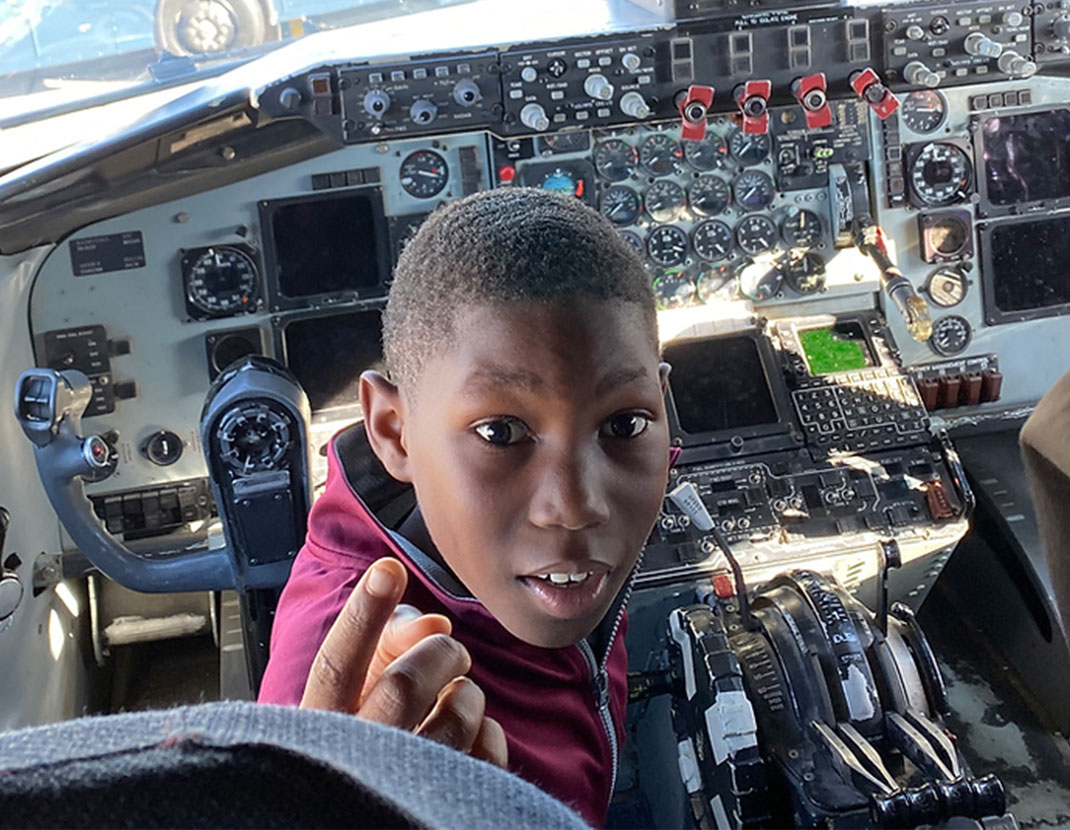 young boy in cockpit of airplane